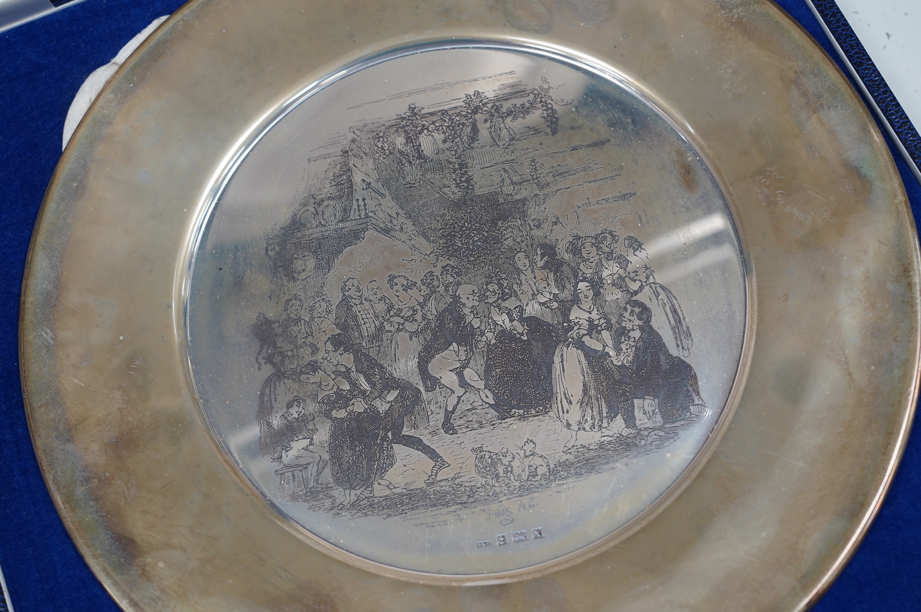 A cased silver plate, with Dickensian scene by Phiz, Birmingham, 1972, Roberts & Dore, 29cm diameter, 25.7oz. Condition - tarnished